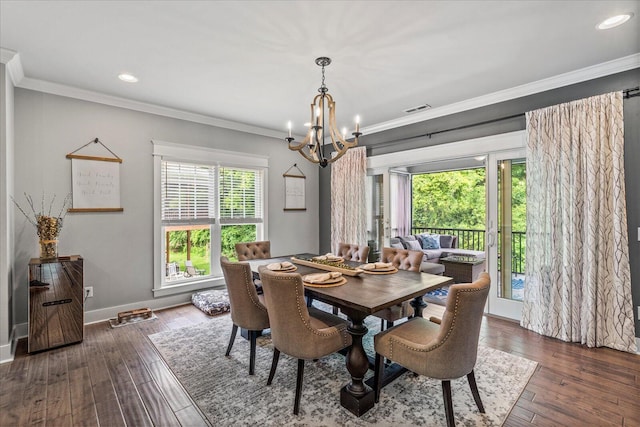 dining space with crown molding and an inviting chandelier