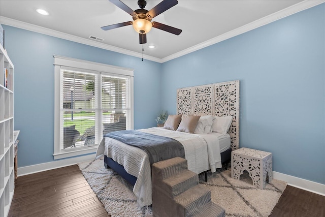 bedroom with crown molding, ceiling fan, and dark hardwood / wood-style floors