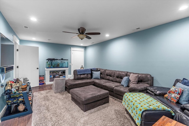 living room featuring hardwood / wood-style flooring and ceiling fan