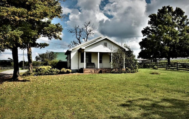 view of front of house with a porch and a front yard