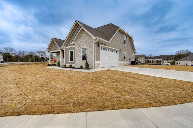 view of front facade with a front lawn, cooling unit, and a garage