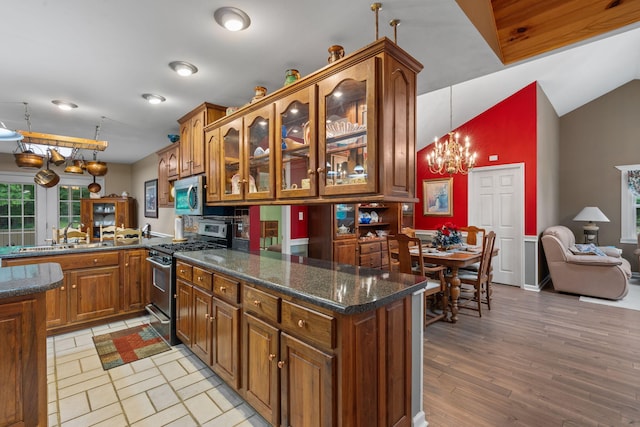 681 Pinhook Rd, Calhoun, TN 37309 - kitchen featuring appliances with stainless steel finishes, a peninsula, a sink, brown cabinetry, and a chandelier