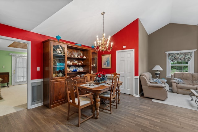 681 Pinhook Rd, Calhoun, TN 37309 - dining area with vaulted ceiling, wood finished floors, a chandelier, and a wainscoted wall