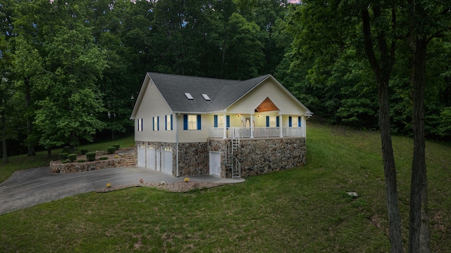 681 Pinhook Rd, Calhoun, TN 37309 - view of front of property featuring stone siding, asphalt driveway, a porch, a garage, and a front lawn
