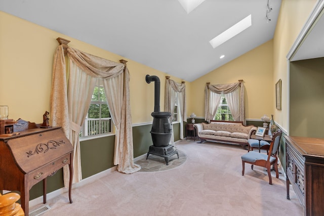 681 Pinhook Rd, Calhoun, TN 37309 - carpeted living area featuring a skylight, vaulted ceiling, a wood stove, and baseboards