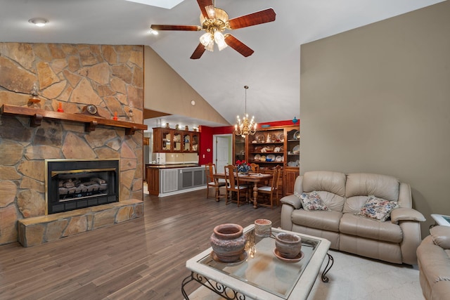 681 Pinhook Rd, Calhoun, TN 37309 - living room with a ceiling fan, high vaulted ceiling, wood finished floors, a fireplace, and a chandelier