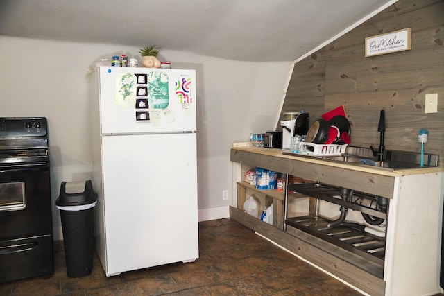 kitchen with white fridge and black / electric stove