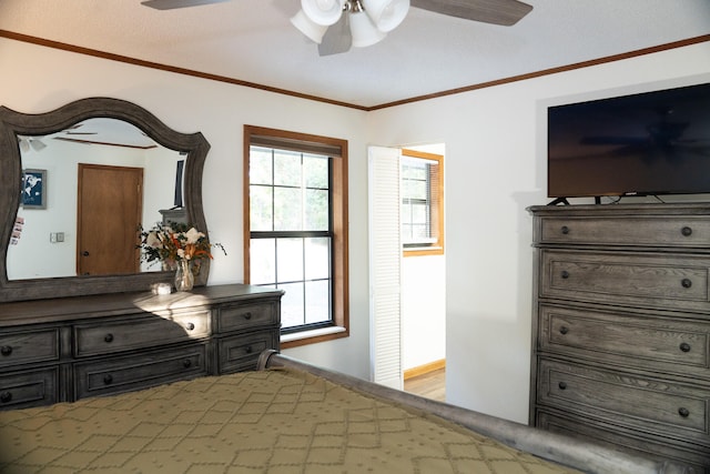 bedroom with a textured ceiling, ceiling fan, crown molding, and hardwood / wood-style floors