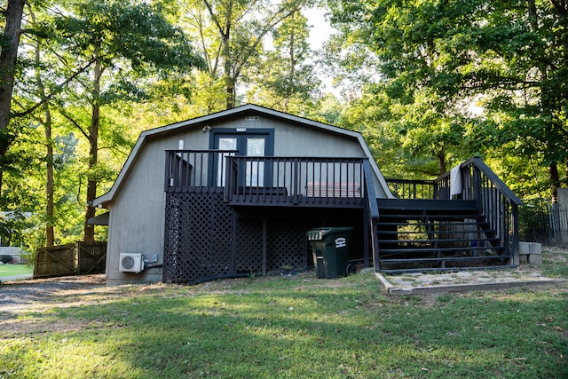 back of house featuring a wooden deck, a yard, and ac unit