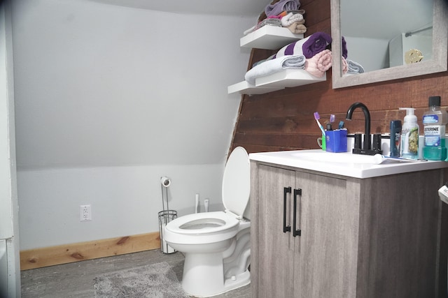 bathroom featuring hardwood / wood-style floors, vanity, and toilet