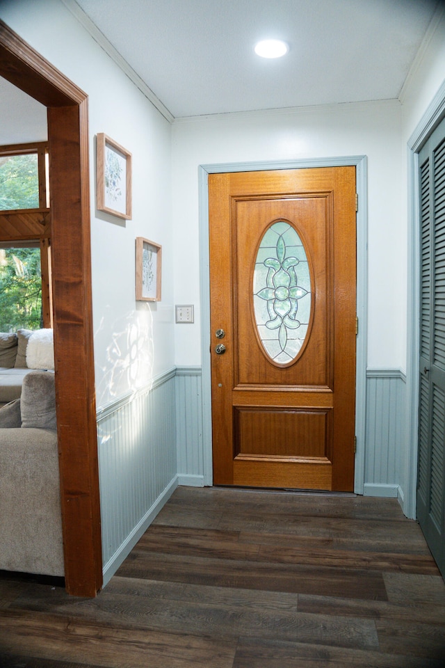 doorway featuring dark hardwood / wood-style flooring and ornamental molding