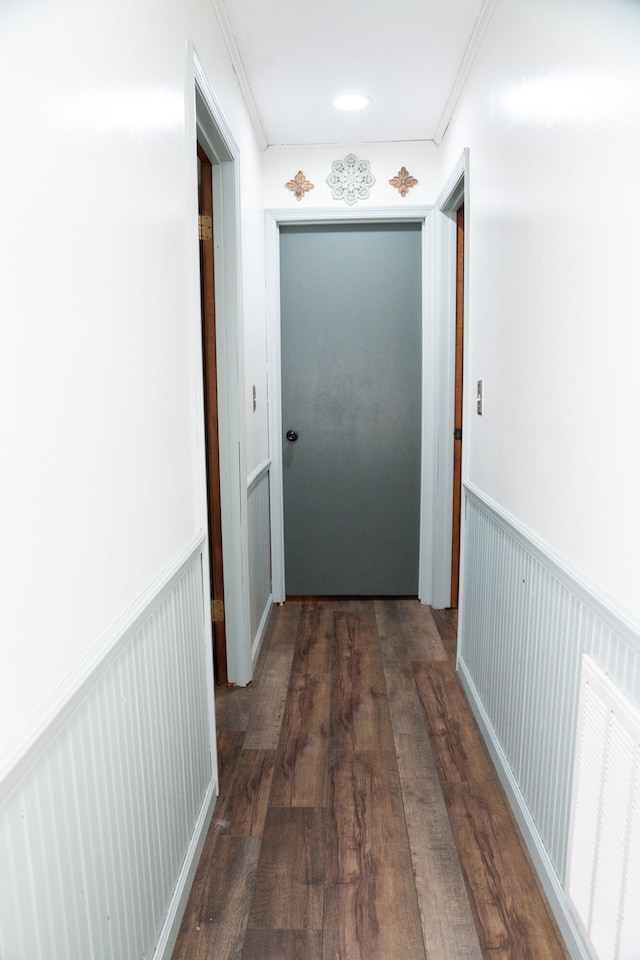 hallway featuring crown molding and dark hardwood / wood-style floors