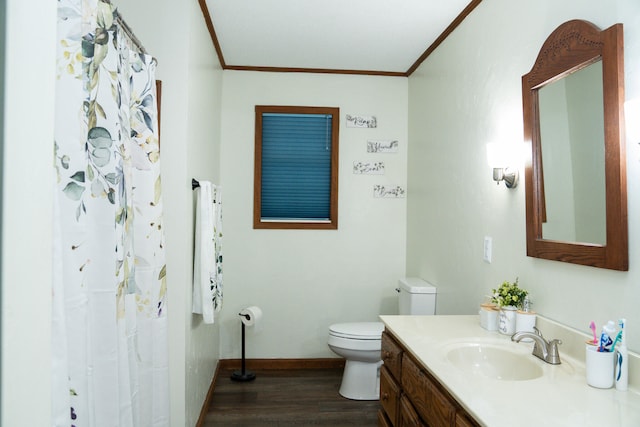 bathroom with toilet, hardwood / wood-style floors, vanity, and ornamental molding