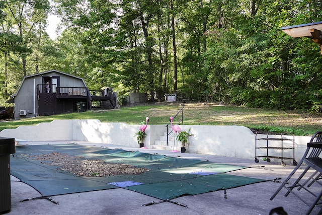 view of swimming pool with a deck