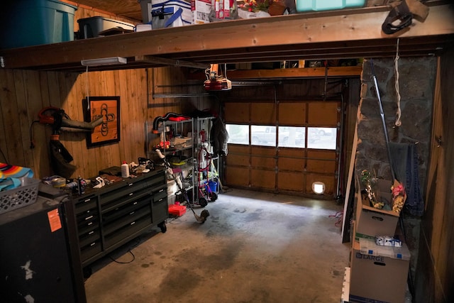 garage with wood walls and a garage door opener