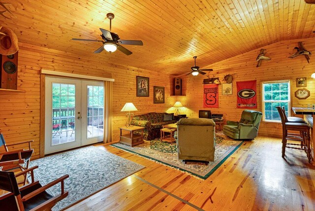 865 Ewing Rd, Spring City, TN 37381 - living area with a ceiling fan, french doors, vaulted ceiling, wooden walls, and wood-type flooring