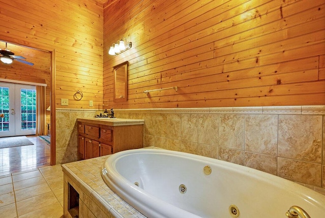865 Ewing Rd, Spring City, TN 37381 - bathroom featuring a whirlpool tub, french doors, vanity, tile patterned floors, and wood walls