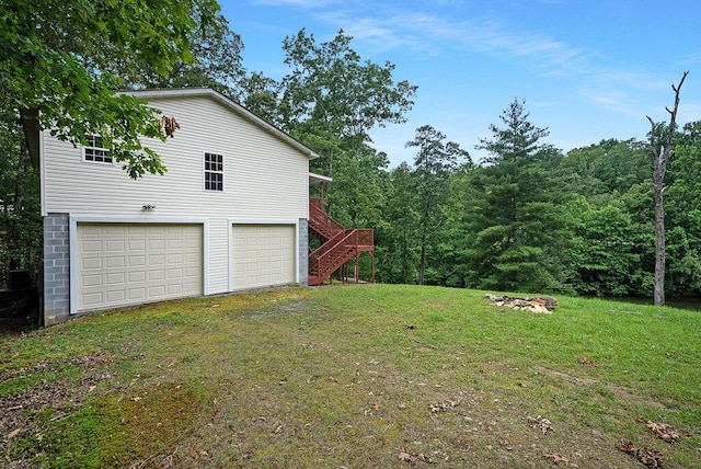 865 Ewing Rd, Spring City, TN 37381 - view of green lawn featuring a garage and stairs
