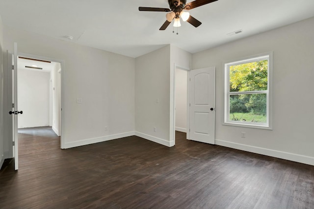 empty room featuring ceiling fan and dark wood-type flooring