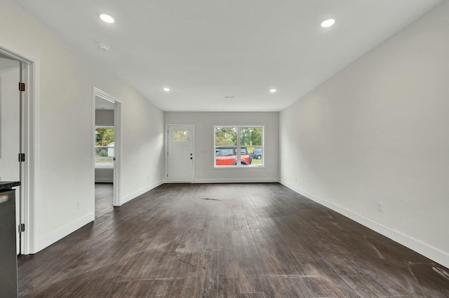 unfurnished living room featuring dark wood-type flooring