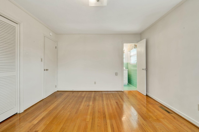 unfurnished bedroom with light hardwood / wood-style floors and ornamental molding