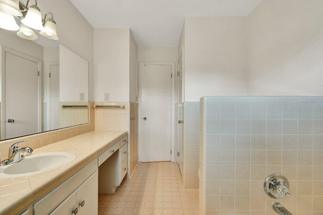 bathroom with vanity, shower / washtub combination, and tile walls