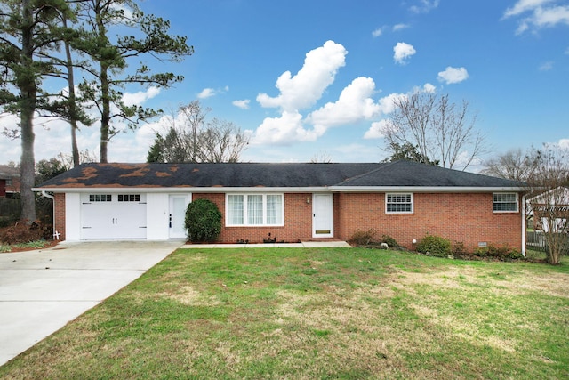 ranch-style house featuring a garage and a front lawn