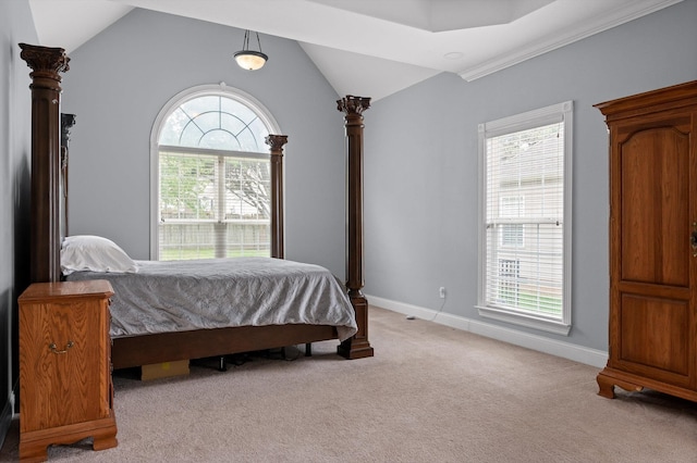 bedroom with baseboards, light carpet, and lofted ceiling