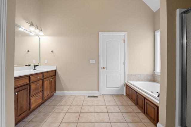 bathroom featuring visible vents, a garden tub, vanity, tile patterned floors, and lofted ceiling
