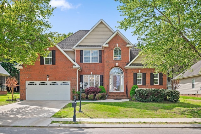 view of front of property with roof with shingles, driveway, an attached garage, a front lawn, and brick siding