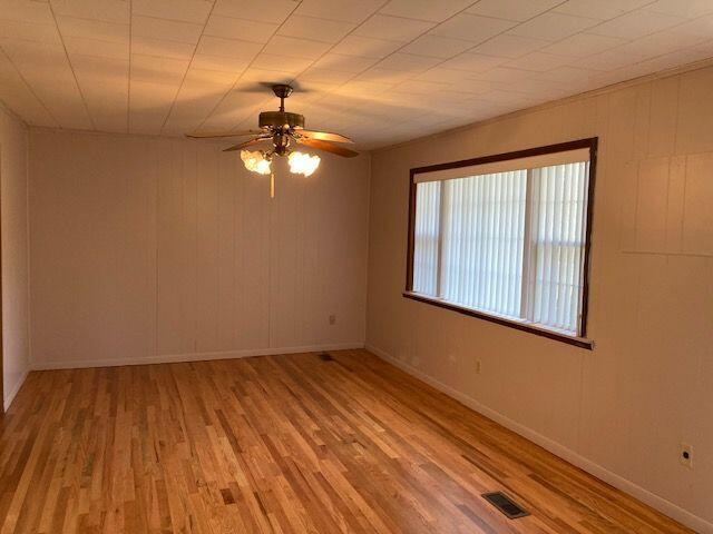 spare room featuring ceiling fan and light wood-type flooring