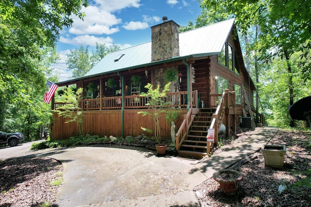 362 River Run Rd, Calhoun, TN 37309 - view of home's exterior with central AC, a chimney, metal roof, stairway, and log exterior