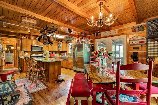362 River Run Rd, Calhoun, TN 37309 - dining area featuring a chandelier, wooden ceiling, beamed ceiling, light wood finished floors, and wooden walls