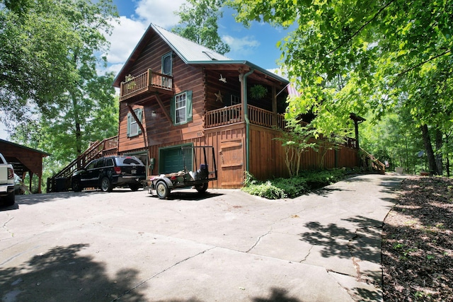 362 River Run Rd, Calhoun, TN 37309 - view of front facade featuring a balcony, stairway, and concrete driveway