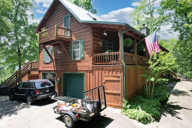 362 River Run Rd, Calhoun, TN 37309 - log cabin with driveway, a balcony, stairway, an attached garage, and a chimney