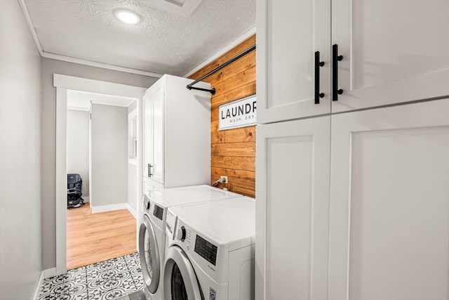 laundry room with recessed lighting, washing machine and dryer, baseboards, cabinet space, and a textured ceiling