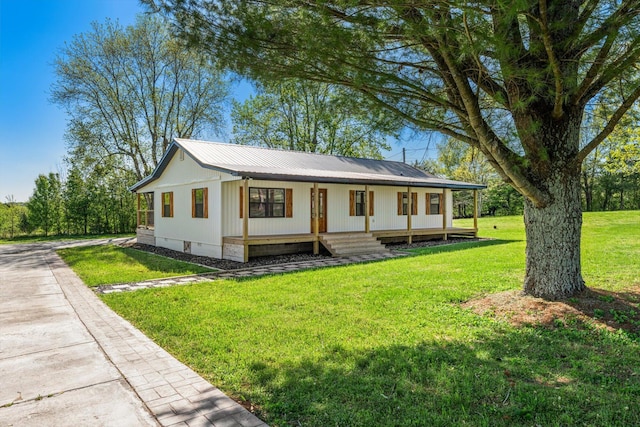 view of front facade featuring crawl space, a front lawn, covered porch, and metal roof