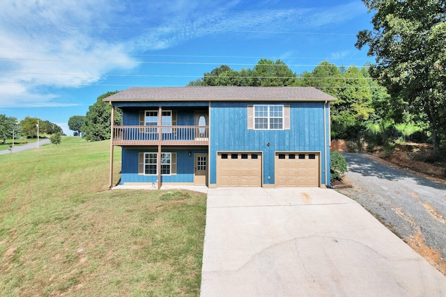 view of front of home with a balcony, a garage, and a front lawn