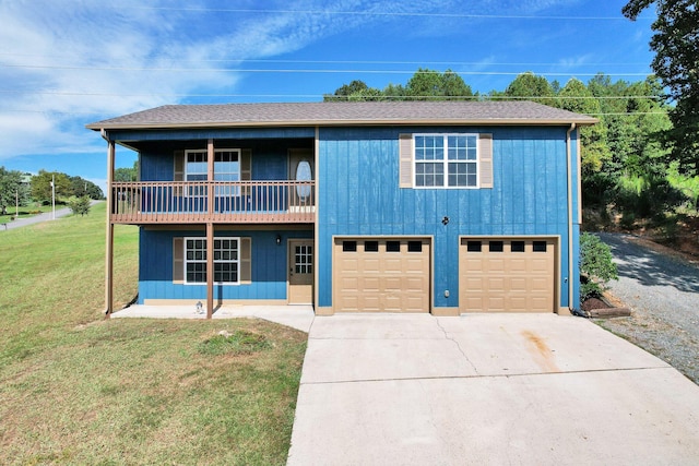 front of property featuring a balcony, a garage, and a front lawn