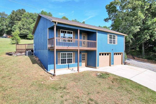 view of front of house featuring a garage, a balcony, and a front yard