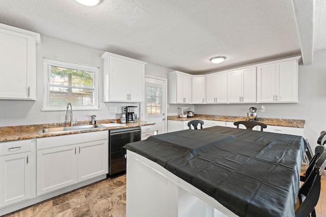 kitchen with dishwasher, white cabinets, a textured ceiling, and sink