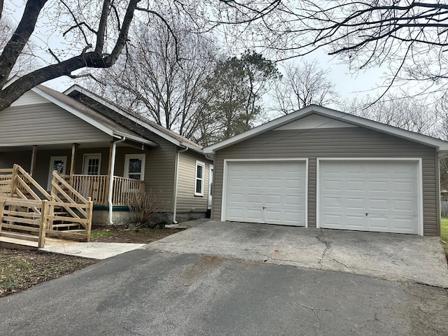 exterior space with a porch and a garage