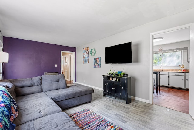 living room with sink and light hardwood / wood-style floors