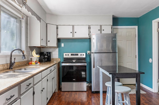 kitchen featuring white cabinets, sink, dark hardwood / wood-style floors, decorative backsplash, and appliances with stainless steel finishes