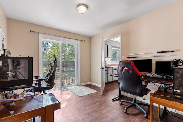 home office with dark hardwood / wood-style floors