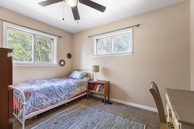 bedroom with carpet flooring, multiple windows, and ceiling fan