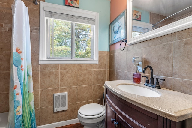 bathroom featuring vanity, heating unit, hardwood / wood-style flooring, tile walls, and toilet