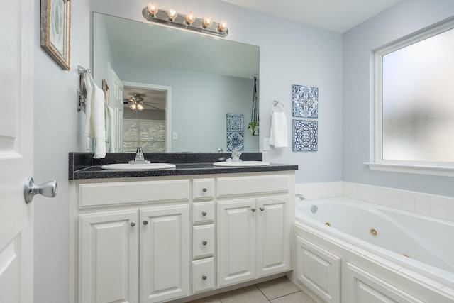 bathroom featuring tile patterned floors, a tub, ceiling fan, and vanity