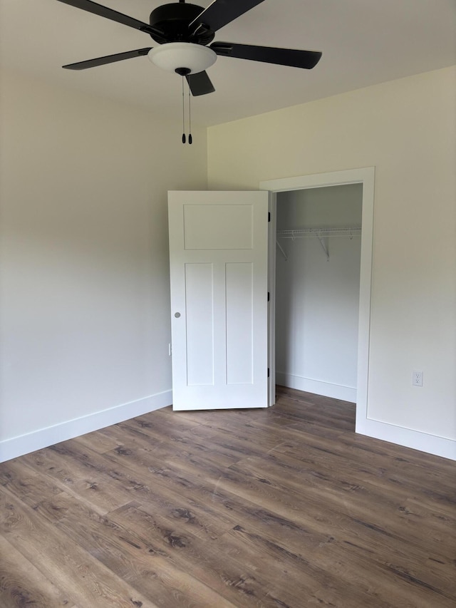 2901 Bobo Ave NW, Cleveland, TN 37312 - unfurnished bedroom with dark wood-style floors, a closet, and a ceiling fan