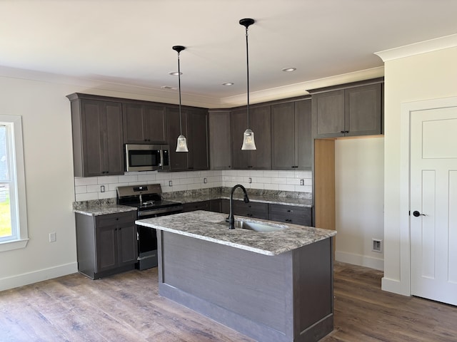 2901 Bobo Ave NW, Cleveland, TN 37312 - kitchen featuring appliances with stainless steel finishes, decorative backsplash, light stone counters, and crown molding